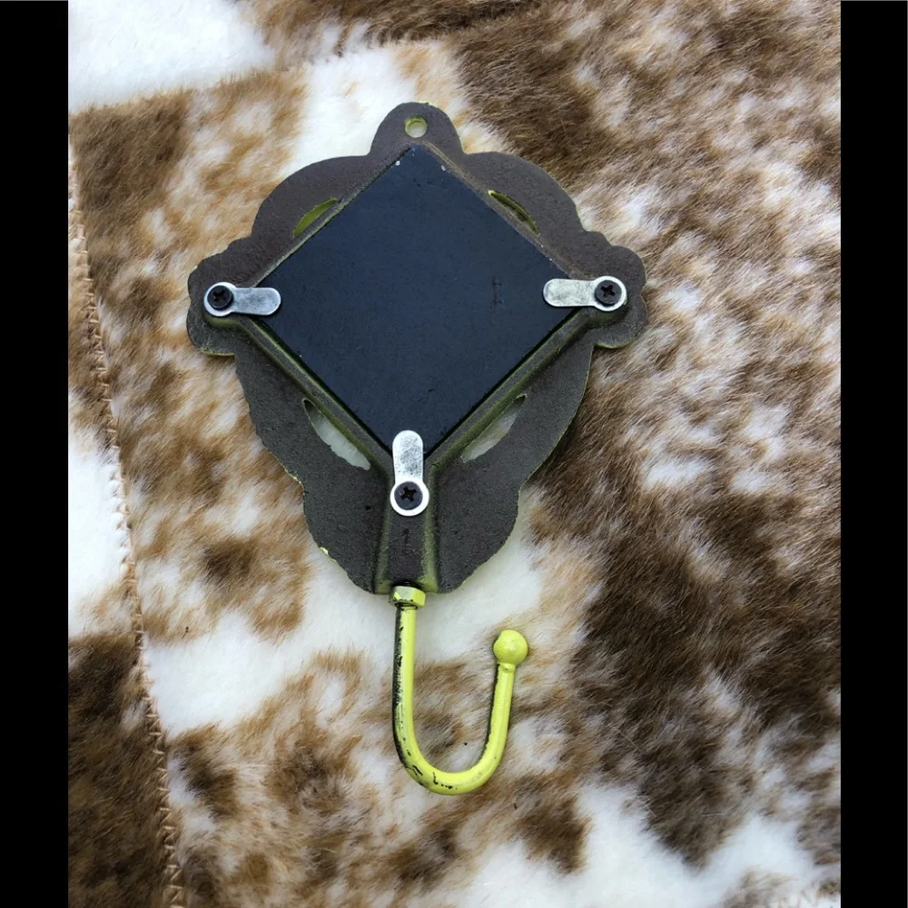 Yellow/green cast iron hook